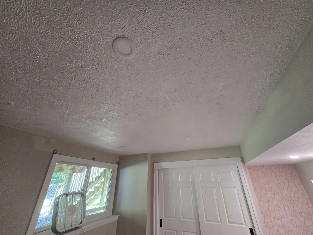 After: ceiling fully repaired, smooth and painted