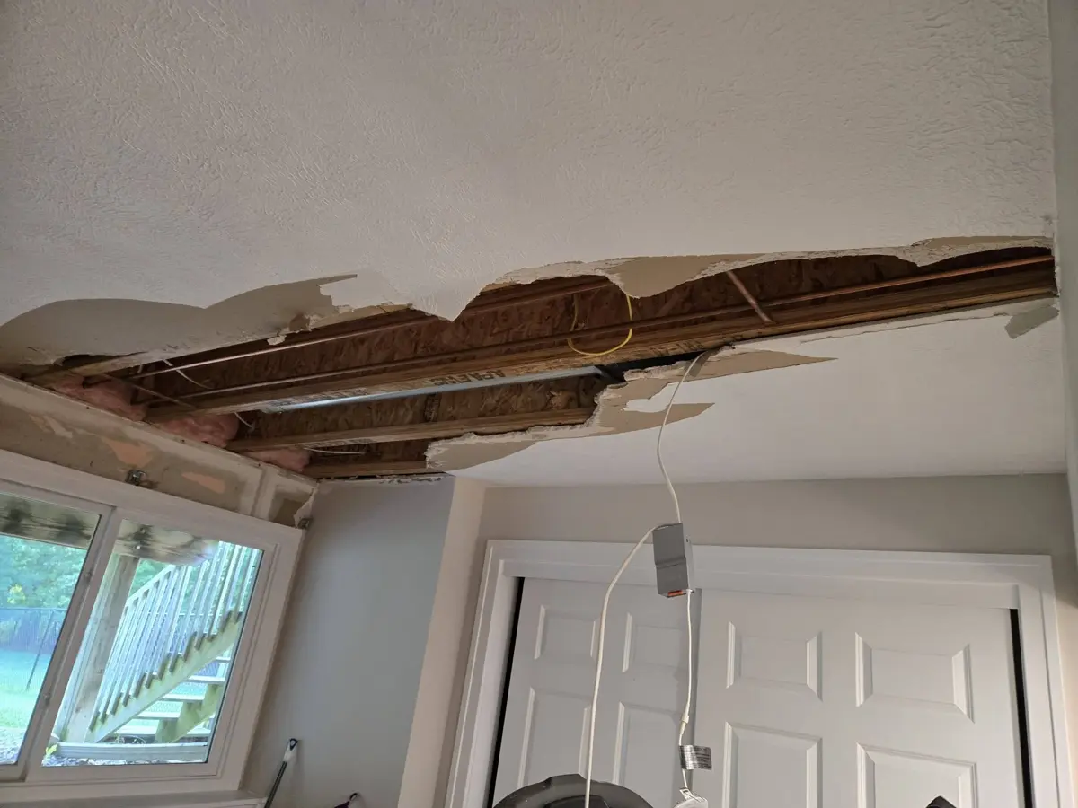 Before: ceiling torn open with exposed joists