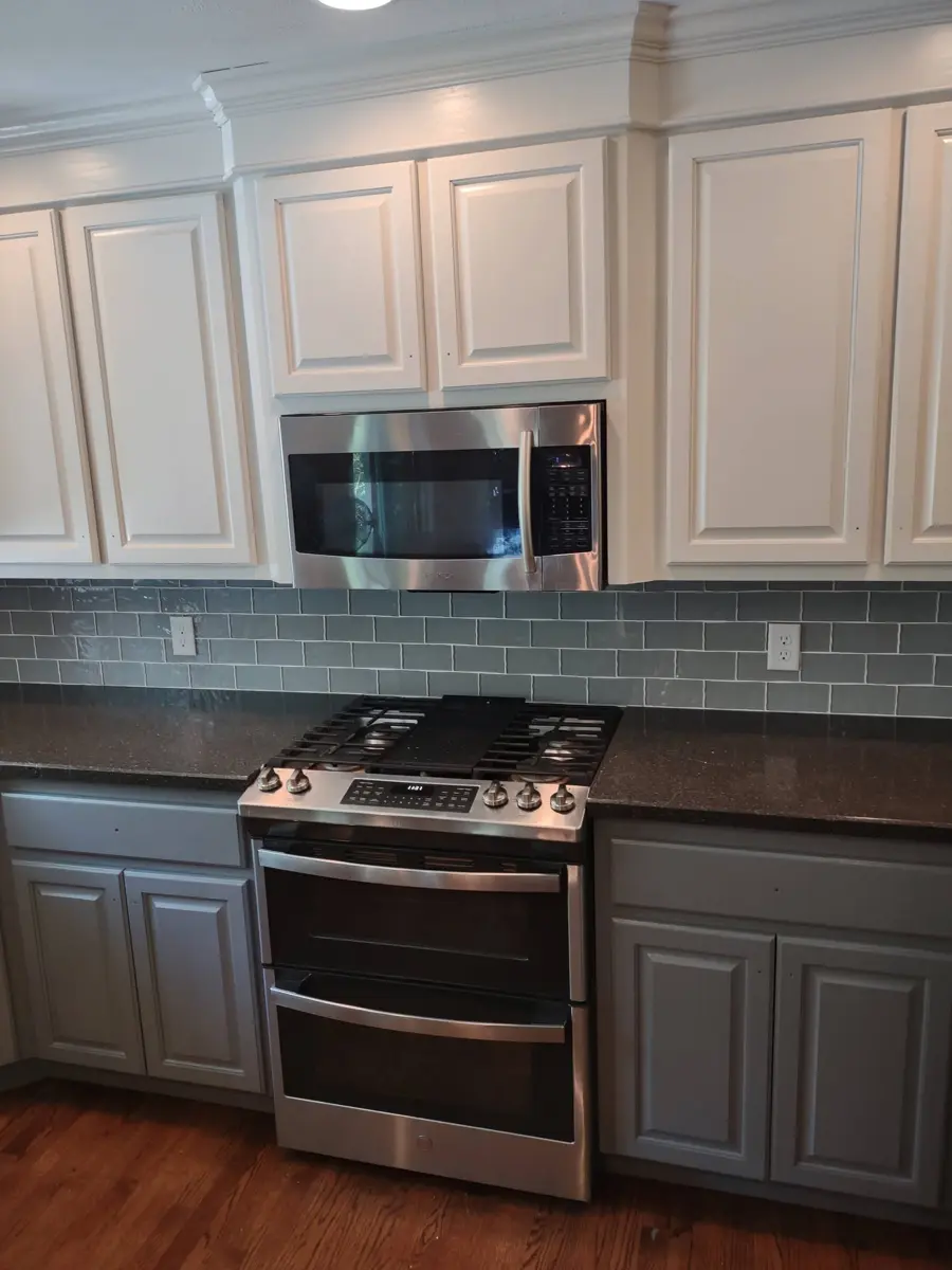 After: kitchen cabinets painted white uppers and gray lowers